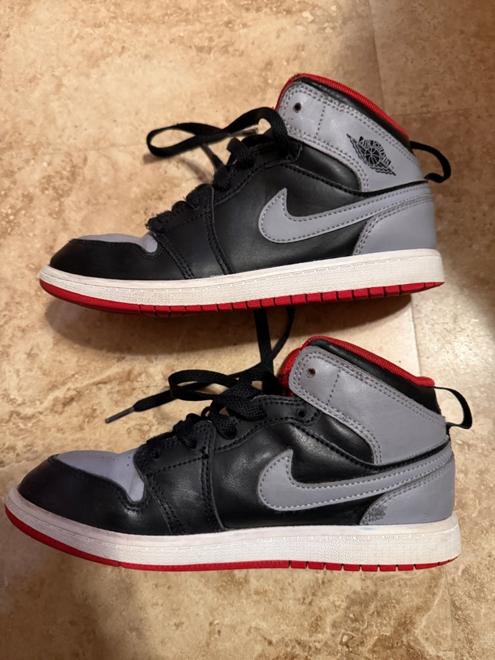 Jordan Kids Black and Gray High-Top Sneakers with Red Outsole Trim